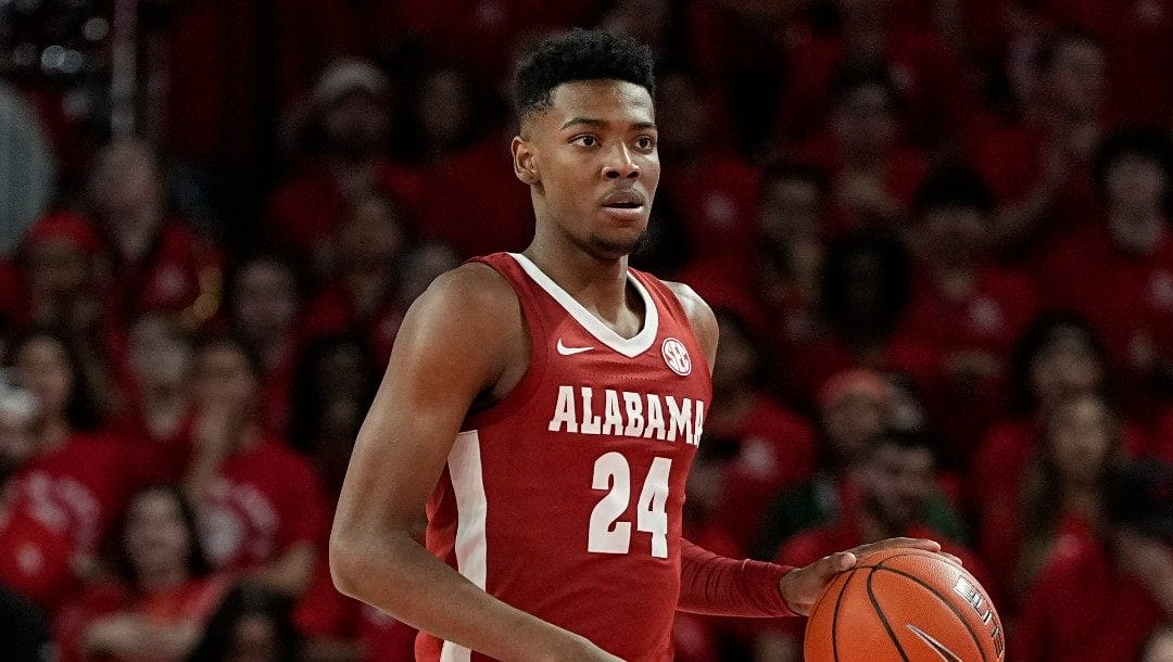 Alabama forward Brandon Miller (24) advances the ball during the first half of an NCAA college basketball game against Houston, Saturday, Dec. 10, 2022, in Houston.