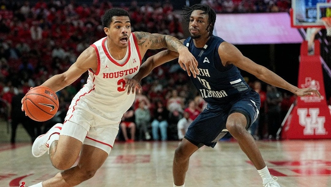 Houston guard Ramon Walker Jr. drives around North Florida guard Jarius Hicklen during the second half of an NCAA college basketball game, Tuesday, Dec. 6, 2022, in Houston.