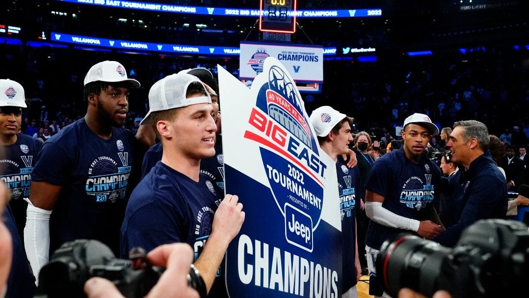 Villanova's Collin Gillespie celebrates with teammates while holding a sign after an NCAA college basketball game against Creighton in the final of the Big East conference tournament Saturday, March 12, 2022, in New York.