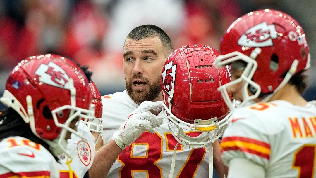 Kansas City Chiefs tight end Travis Kelce (87) puts on his helmet during the second half of an NFL football game Sunday, Dec. 18, 2022, in Houston. The Chiefs won 30-24 in overtime.