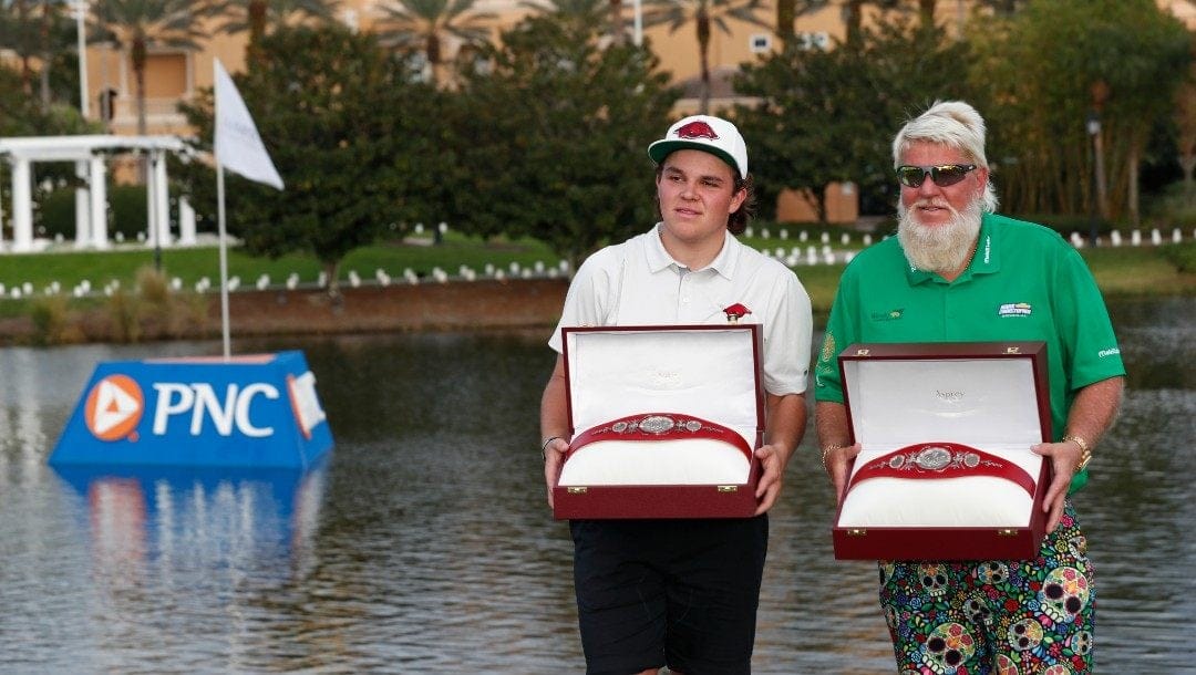 John Daly, right, stands with son John Daly II after winning the PNC Championship golf tournament Sunday, Dec. 19, 2021, in Orlando, Fla.