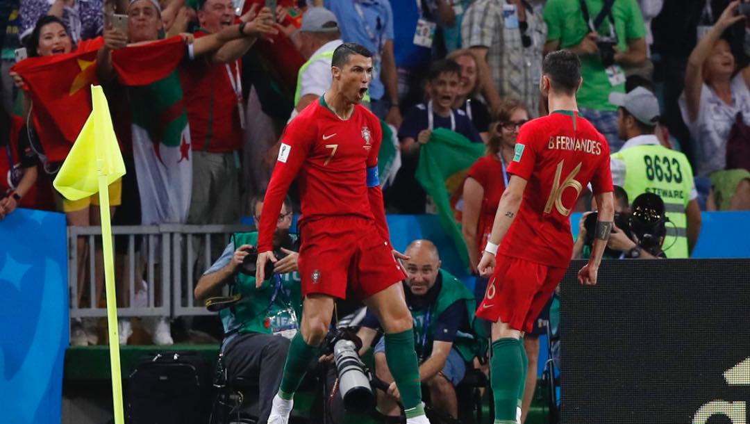 Portugal's Cristiano Ronaldo, left, celebrates with teammate Portugal's Bruno Fernandes after he scored his sides 1st goal from the penalty spot during the group B match between Portugal and Spain at the 2018 soccer World Cup in the Fisht Stadium in Sochi, Russia, Friday, June 15, 2018.