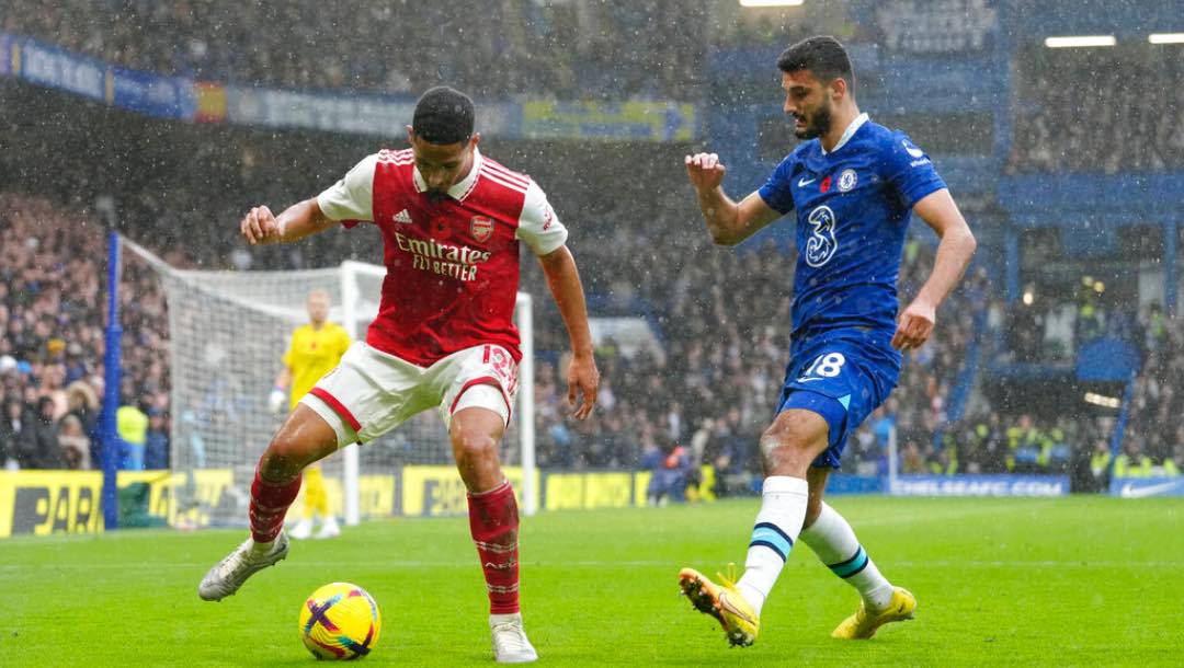 Arsenal's William Saliba, left, and Chelsea's Armando Broja challenge for the ball during the English Premier League soccer match between Chelsea and Arsenal at Stamford Bridge Stadium in London, Sunday, Nov. 6, 2022.