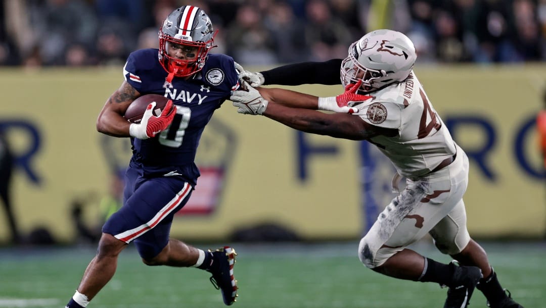 Navy fullback Chance Warren (0) runs against Army during the second half of an NCAA college football game Saturday, Dec. 11, 2021, in East Rutherford, N.J. Navy won 17-13. (AP Photo/Adam Hunger)