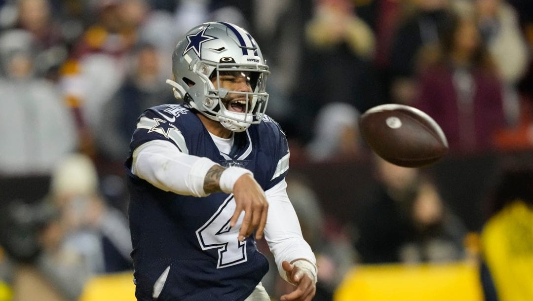 Dallas Cowboys quarterback Dak Prescott (4) throws the ball away while in the end zone during the second half an NFL football game against the Washington Commanders, Sunday, Jan. 8, 2023, in Landover, Md. (AP Photo/Alex Brandon)