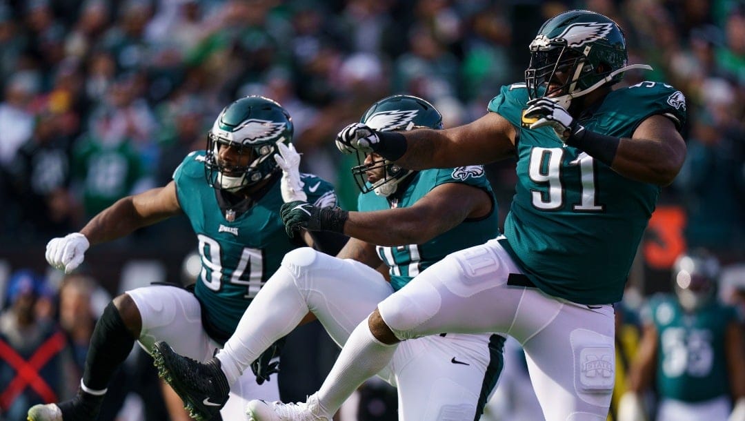 Philadelphia Eagles nose tackle Javon Hargrave (97), center, celebrates his sack with defensive end Josh Sweat (94) and defensive end Fletcher Cox (91) during the NFL football game against the Tennessee Titans, Sunday, Dec. 4, 2022, in Philadelphia. (AP Photo/Chris Szagola)