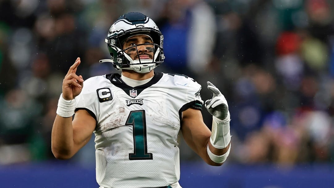 Philadelphia Eagles quarterback Jalen Hurts (1) reacts after a touchdown against the New York Giants during an NFL football game Sunday, Dec. 11, 2022, in East Rutherford, N.J. (AP Photo/Adam Hunger)