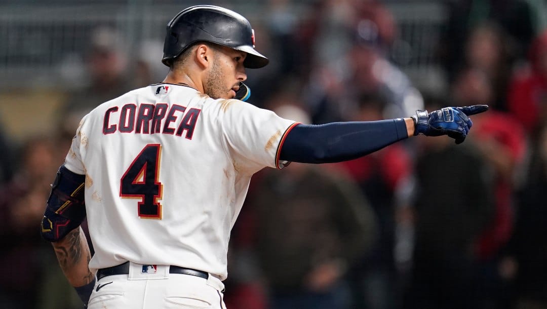 Minnesota Twins' Carlos Correa celebrates while crossing home plate after hitting a two-run home run during the eighth inning of the team's baseball game against the Cleveland Guardians, Friday, Sept. 9, 2022, in Minneapolis.