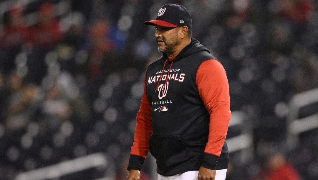 Washington Nationals manager Dave Martinez (4) walks on the field during the second baseball game of a doubleheader against the Philadelphia Phillies, Saturday, Oct. 1, 2022, in Washington.