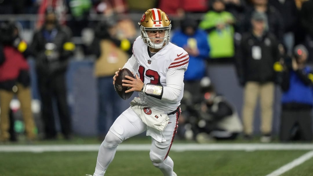 San Francisco 49ers quarterback Brock Purdy rolls out of the pocket