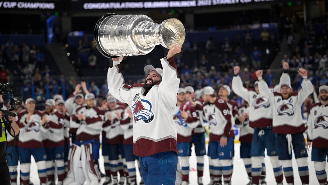 Colorado Avalanche center Nazem Kadri (91) lifts the Stanley Cup after the team defeated the Tampa Bay Lightning in Game 6 of the NHL hockey Stanley Cup Finals on Sunday, June 26, 2022, in Tampa, Fla.
