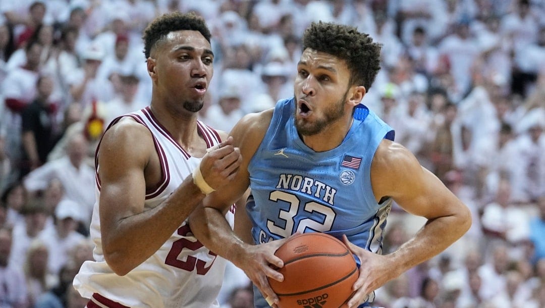 North Carolina's Pete Nance (32) goes to the basket against Indiana's Trayce Jackson-Davis (23) during the first half of an NCAA college basketball game, Wednesday, Nov. 30, 2022, in Bloomington, Ind. (AP Photo/Darron Cummings)