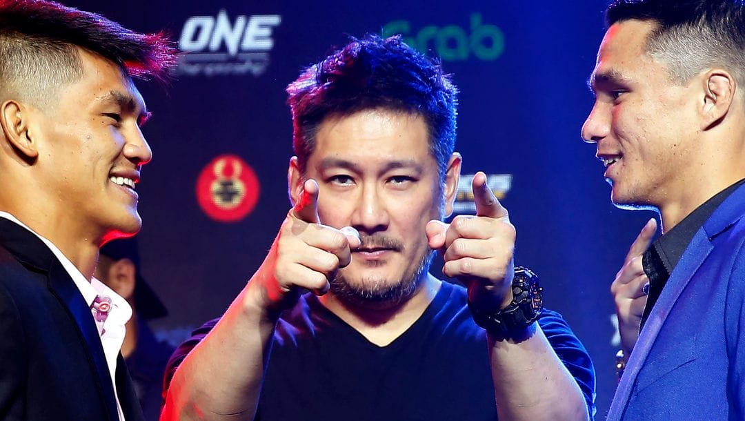 FILE - In this July 30, 2019, file photo, One Championship founder Chatri Sityodtong, center, gestures as Reece McLaren, right, of Australia and Danny Kingad, of the Philippines.