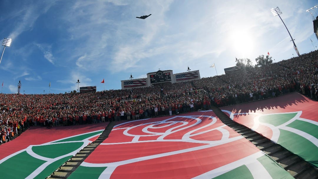 The Rose Bowl logo is seen during a fly over before the Rose Bowl NCAA college football game between Utah and Ohio State Saturday, Jan. 1, 2022, in Pasadena, Calif. Flipping the current college football playoff from four-teams to a 12-teams for the final two years of the current television contract will give those in charge of the postseason a look at how it works before committing to anything long term. But, The Granddaddy of Them All wants the CFP management committee to assure game organizers that their game will continue to be played annually on New Year's Day. (AP Photo/Mark J. Terrill, File)