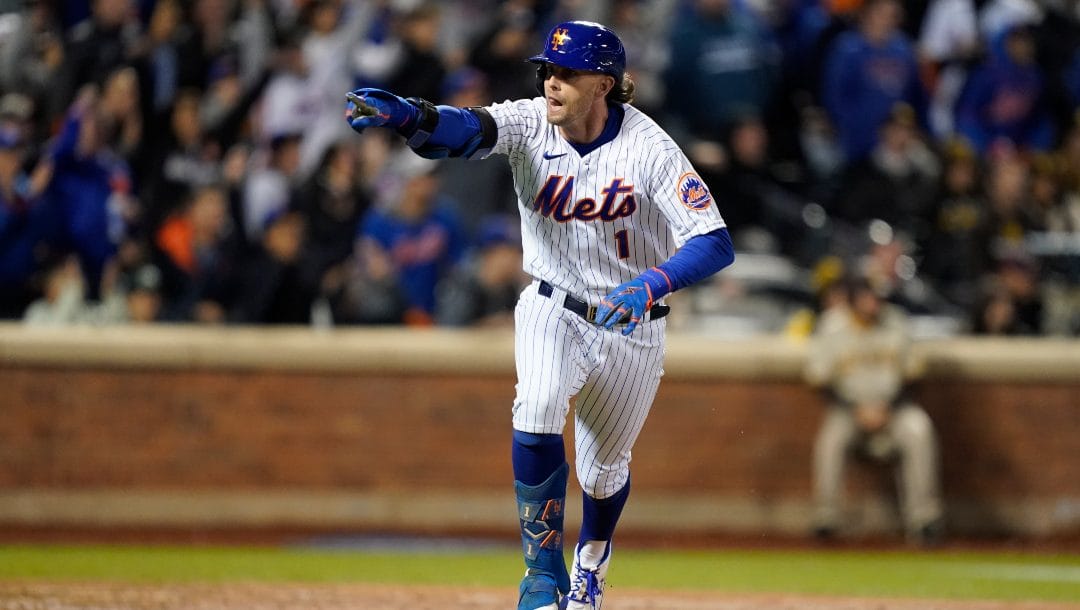 New York Mets Jeff McNeil (1) reacts as he heads up the first base line after hitting a two-run double against the San Diego Padres during the seventh inning of Game 2 of a National League wild-card baseball playoff series, Saturday, Oct. 8, 2022, in New York.