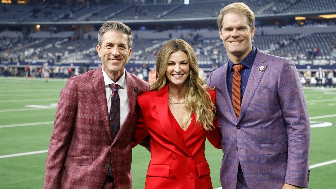 FOX broadcasters, from left to right, Kevin Burkhardt, Erin Andrews and Greg Olsen pose on the sideline before an NFL football game between the New York Giants and Dallas Cowboys Thursday, Nov. 24, 2022, in Arlington, Texas.