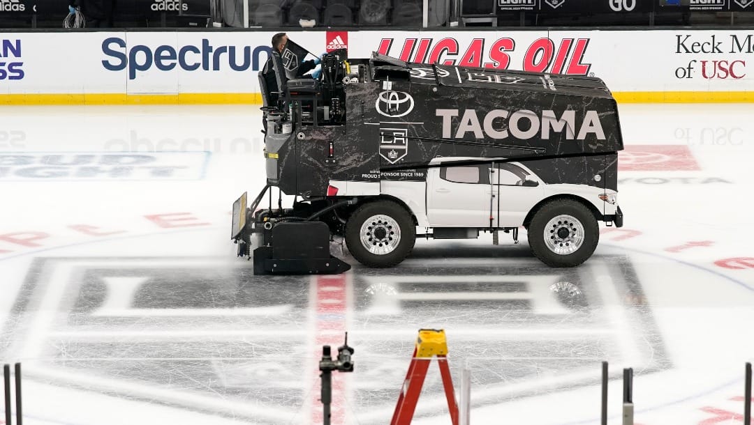 A Zamboni resurfaces the ice after an NHL hockey game between the Los Angeles Kings and the Calgary Flames, Dec. 2, 2021, in Los Angeles. On game days, the Kings use 800 to 1,200 gallons to maintain the ice. (AP Photo/Mark J. Terrill)