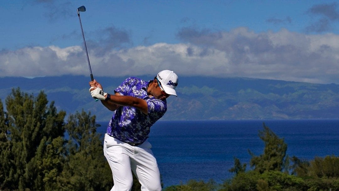 Hideki Matsuyama, of Japan, plays his shot from the eighth tee during the third round of the Tournament of Champions golf event, Saturday, Jan. 7, 2023, at Kapalua Plantation Course in Kapalua, Hawaii.