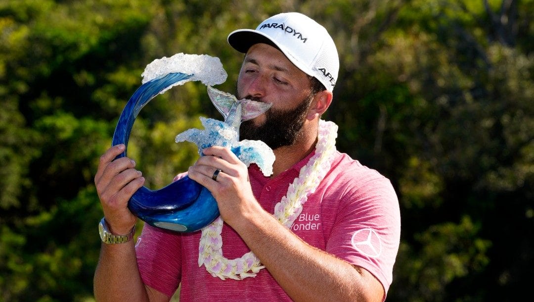 Jon Rahm, of Spain, kisses the champions trophy after the final round of the Tournament of Champions golf event, Sunday, Jan. 8, 2023, at Kapalua Plantation Course in Kapalua, Hawaii.