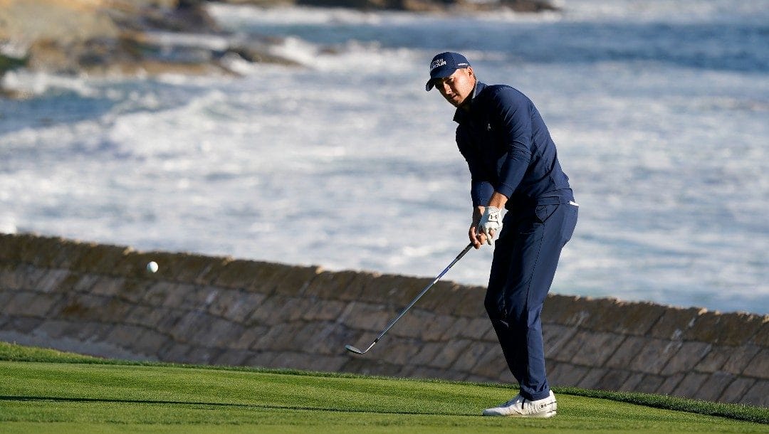 Jordan Spieth chips onto the 18th green of the Pebble Beach Golf Links during the final round of the AT&T Pebble Beach Pro-Am golf tournament in Pebble Beach, Calif., Sunday, Feb. 6, 2022.