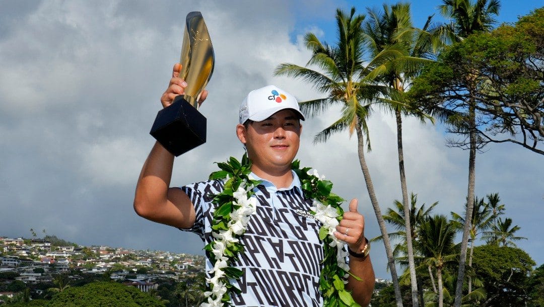 Si Woo Kim holds the champions trophy after the final round of the Sony Open golf tournament, Sunday, Jan. 15, 2023, at Waialae Country Club in Honolulu.