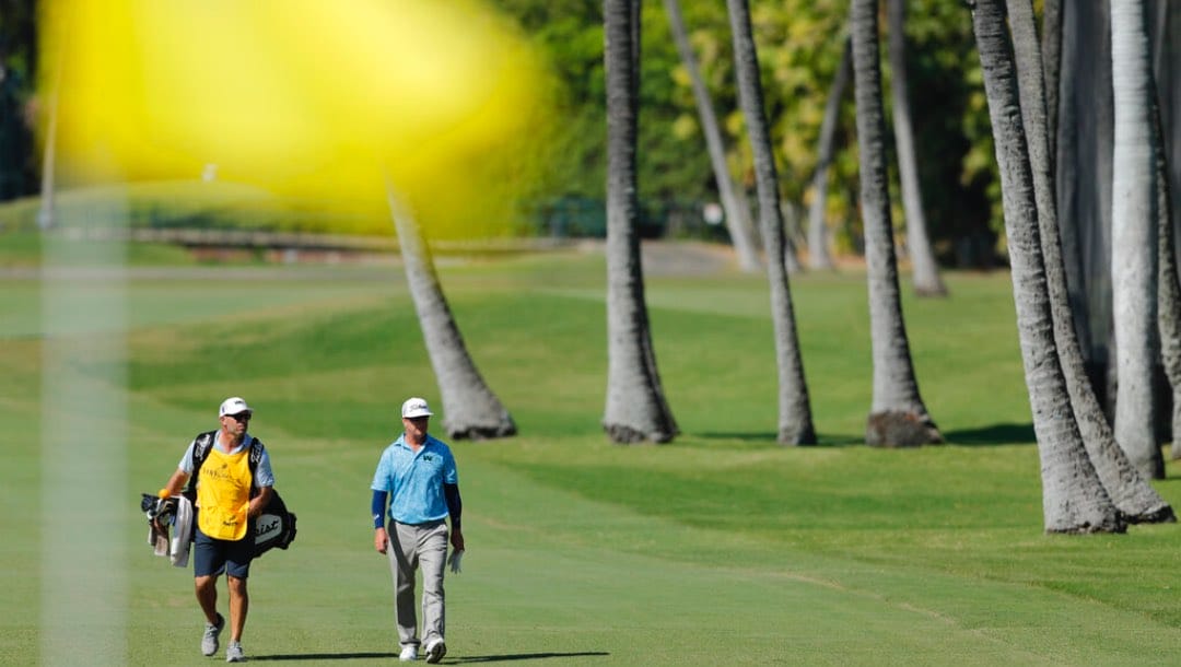 Charley Hoffman, right, walks towards the ninth green during the second round of the Sony Open golf tournament Friday, Jan. 15, 2021, at Waialae Country Club in Honolulu.