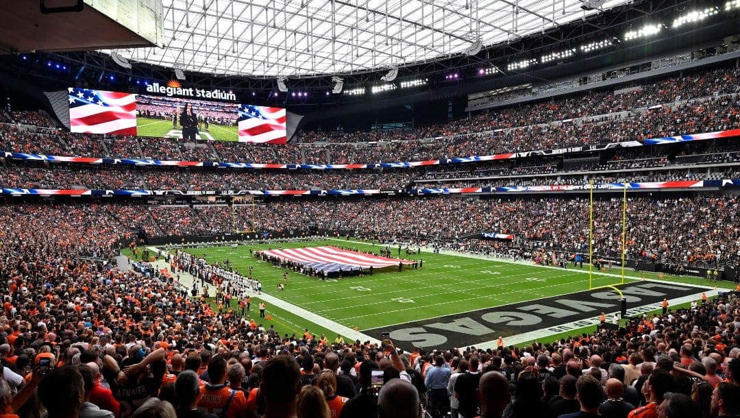 Spectators stand during the national anthem before an NFL football game between the Las Vegas Raiders and the Denver Broncos at Allegiant Stadium Sunday, Oct. 2, 2022, in Las Vegas. (AP Photo/David Becker)