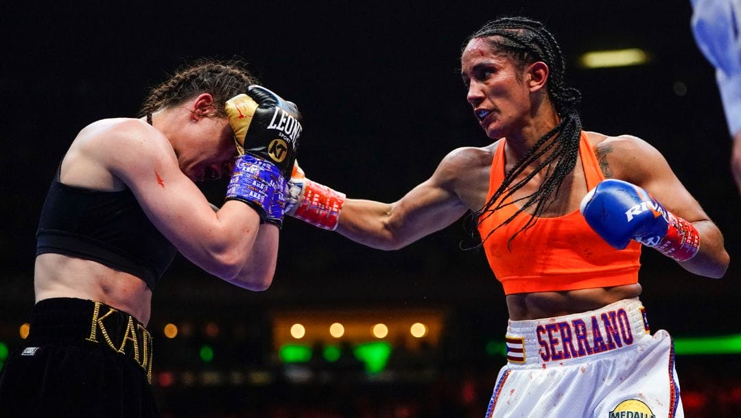 Amanda Serrano, right, punches Ireland's Katie Taylor during the sixth round of a lightweight championship boxing match.