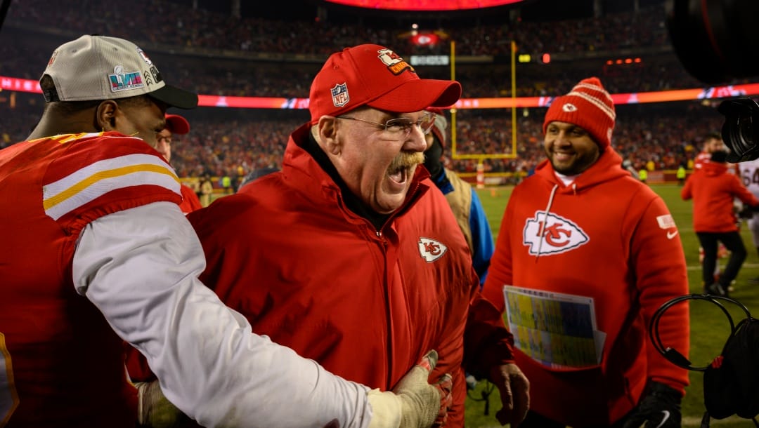 With "Super Bowl Bound" on the scoreboard behind them, Kansas City Chiefs head coach Andy Reid, center, celebrates with Kansas City Chiefs defensive end Frank Clark, left, after they beat the Cincinnati Bengals in the NFL AFC Championship playoff football game, Sunday, Jan. 29, 2023 in Kansas City, Mo. (AP Photo/Reed Hoffmann)