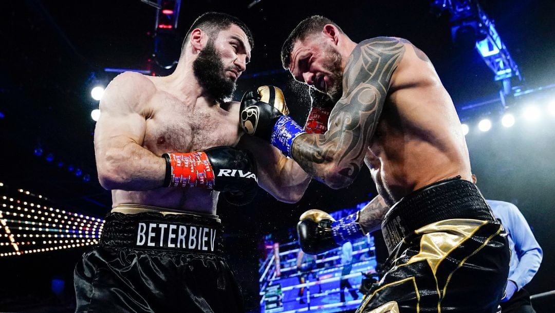 Artur Beterbiev, left, punches Joe Smith Jr. during the second round of a light heavyweight boxing bout Saturday, June 18, 2022.