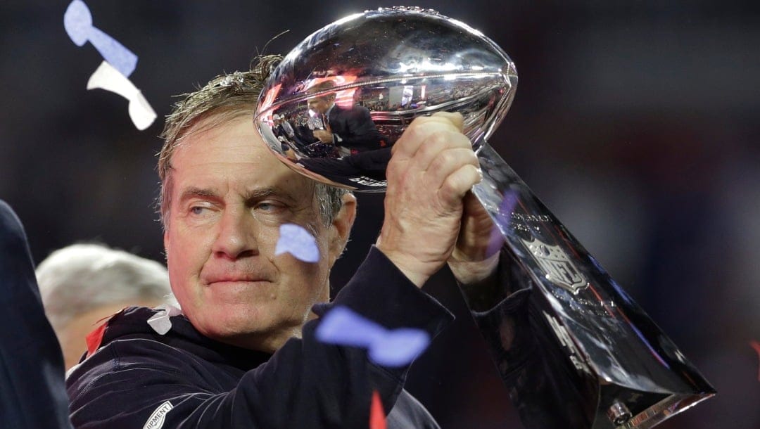 New England Patriots head coach Bill Belichick holds up the Vince Lombardi Trophy as he celebrates after the Patriots defeated the Seattle Seahawks 28-24 in NFL Super Bowl XLIX football game Sunday, Feb. 1, 2015, in Glendale, Ariz. (AP Photo/Patrick Semansky)