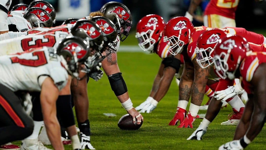 FILE - In this Feb. 7, 2021, file photo, the Tampa Bay Buccaneers offense, left, gets set at the line of scrimmage against the Kansas City Chiefs defense during the second half of the NFL Super Bowl 55 football game in Tampa, Fla. As COVID-19 and Delta variant positives increase across America, the NFL kicks off its first preseason since 2019 expecting the usual crowds. The league says more than 90% of its players have either begun or concluded the vaccination process. Nine teams have more than 95% of their players vaccinated, while a total of 27 teams is above 85%. (AP Photo/Steve Luciano, File)