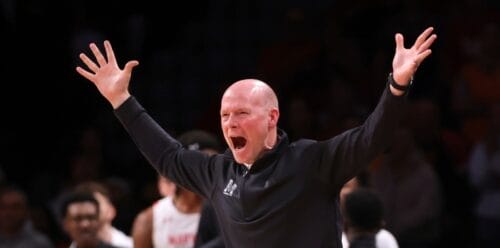 The Maryland Terrapins coach shouting with his arms up in the air