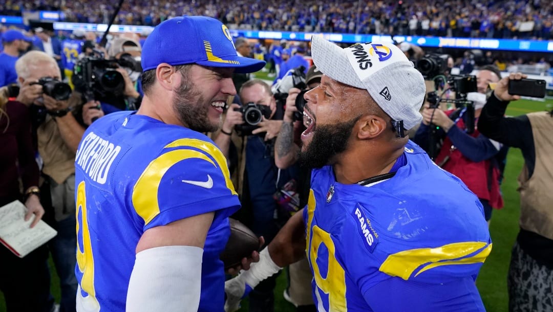 FILE - Los Angeles Rams' Matthew Stafford, left, and Aaron Donald celebrate after the NFC Championship NFL football game against the San Francisco 49ers Sunday, Jan. 30, 2022, in Inglewood, Calif. Stafford, Donald and the Los Angeles Rams will raise their Super Bowl banner Thursday night before kicking off the NFL season at home where they became the first team to hoist the Vince Lombardi trophy in their own stadium. (AP Photo/Marcio Jose Sanchez, File)