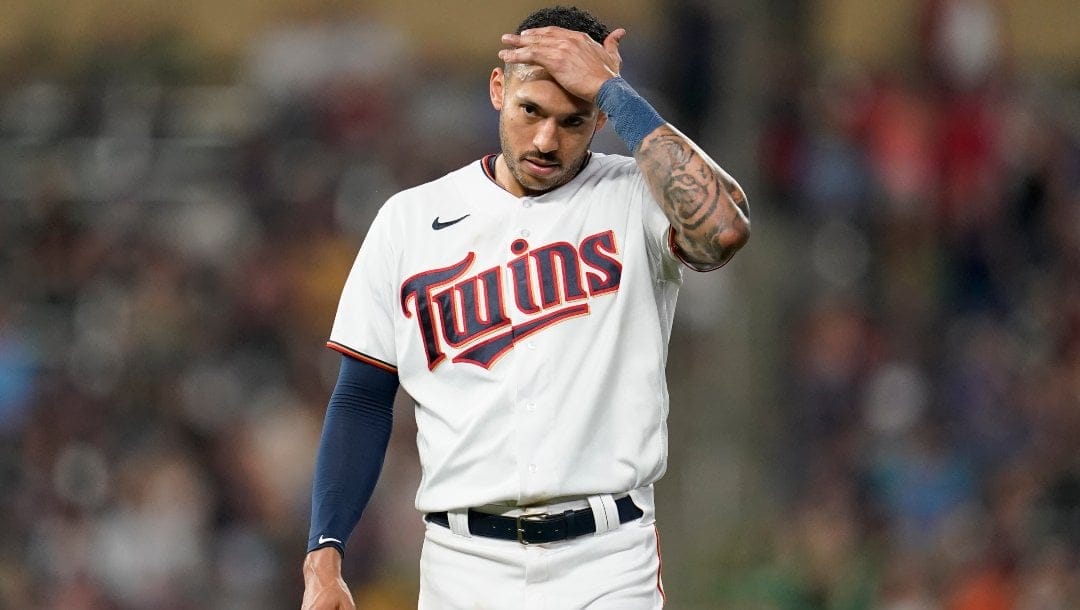 Minnesota Twins' Carlos Correa reacts after the bottom of the fifth inning of a baseball game against the San Francisco Giants, Saturday, Aug. 27, 2022, in Minneapolis.