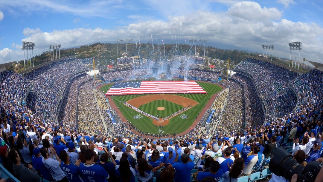 Fans listen to the National Anthem during the Los Angeles Dodgers' Opening Day baseball game against the San Francisco Giants at Dodger Stadium, Monday, April 1, 2013, in Los Angeles.