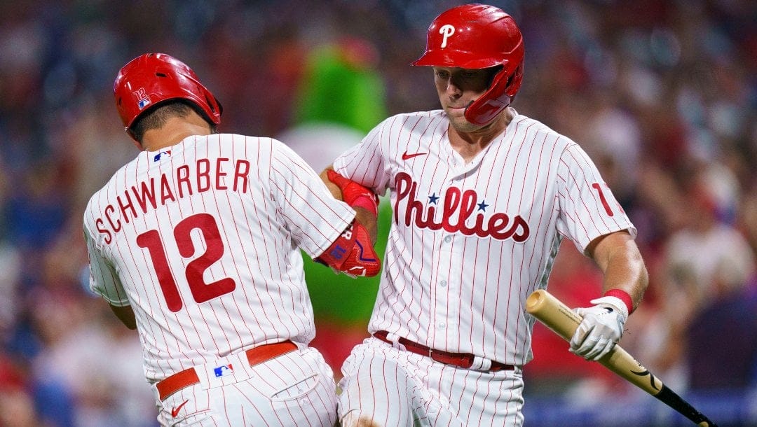 Philadelphia Phillies' Kyle Schwarber, left, celebrates his home run with Rhys Hoskins, right, during the seventh inning of a baseball game against the Washington Nationals, Friday, Aug. 5, 2022, in Philadelphia.