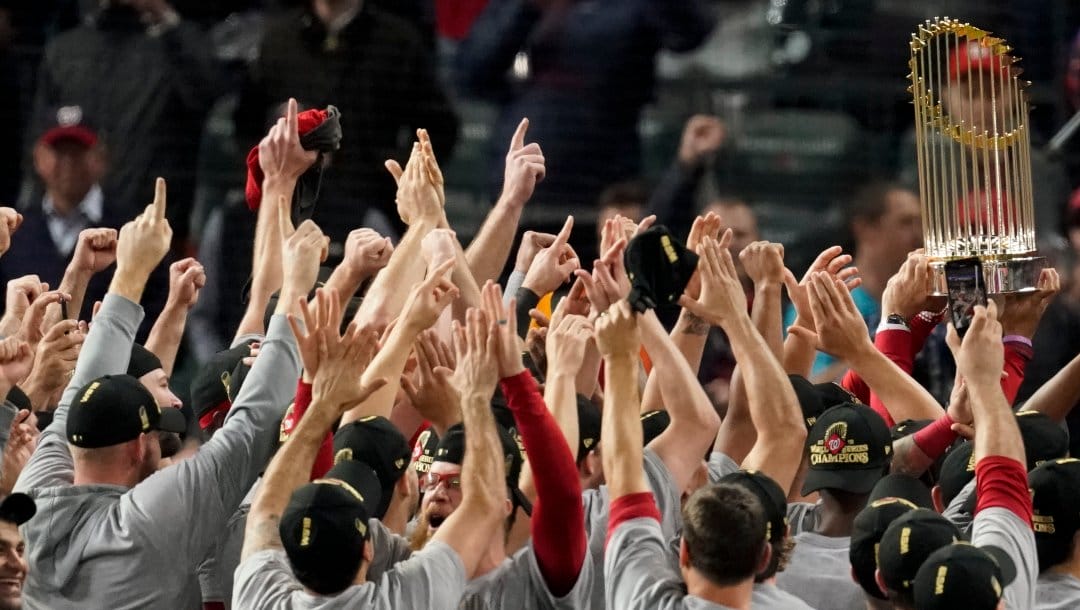 The Washington Nationals celebrate with the trophy after Game 7 of the baseball World Series against the Houston Astros Wednesday, Oct. 30, 2019, in Houston. The Nationals won 6-2 to win the series.
