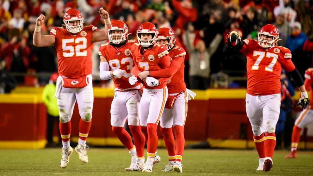 Kansas City Chiefs place kicker Harrison Butker (7) is hugged by Chiefs punter Tommy Townsend as Chiefs center Creed Humphrey (52), Chiefs tight end Noah Gray (83) and Chiefs guard Andrew Wylie (77) celebrate after he kicked the winning field goal against the Cincinnati Bengals \ during the second half of the NFL AFC Championship playoff football game, Sunday, Jan. 29, 2023 in Kansas City, Mo. (AP Photo/Reed Hoffmann)