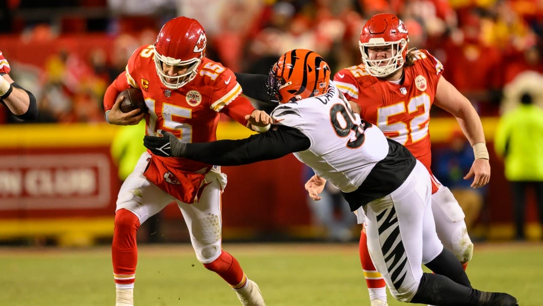 Kansas City Chiefs quarterback Patrick Mahomes (15) is tackled by Cincinnati Bengals defensive tackle Zach Carter (95) during the second half of the NFL AFC Championship playoff football game, Sunday, Jan. 29, 2023 in Kansas City, Mo. (AP Photo/Reed Hoffmann)