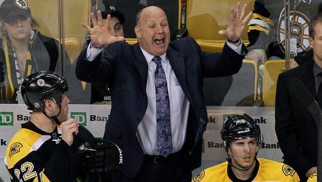 Boston Bruins head coach Claude Julien yells from the bench as right wing Shawn Thornton (22) and center David Krejci (46), of Czech Republic, look on in the third period of an NHL hockey game against the New York Rangers in Boston, Tuesday, Feb. 14, 2012. The Rangers won 3-0.