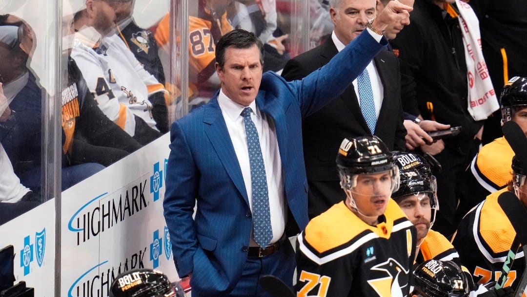 Pittsburgh Penguins head coach Mike Sullivan gives instructions from behind his bench during the first period of an NHL hockey game against the Carolina Hurricanes in Pittsburgh, Tuesday, Nov. 29, 2022. The Hurricanes won in overtime 3-2.