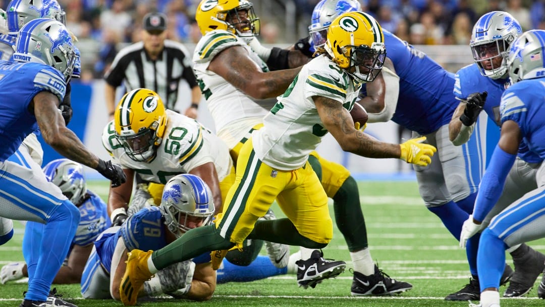 Green Bay Packers running back AJ Dillon (28) rushes against the Detroit Lions during an NFL football game, Sunday, Nov. 6, 2022, in Detroit. (AP Photo/Rick Osentoski)