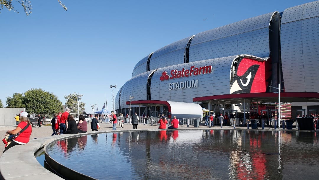 FILE - In this Thursday, Oct. 31, 2019, file photo, fans arrive prior to an NFL football game at State Farm Stadium in Glendale, Ariz. Governor Doug Ducey and the Arizona Department of Health Services announced Friday, Jan. 8, 2021, that Arizona will open a 24/7 vaccination site Monday, Jan. 11, 2021 at State Farm Stadium to dramatically expand the availability of COVID-19 vaccine doses in the Phoenix metropolitan area. (AP Photo/Rick Scuteri, File)