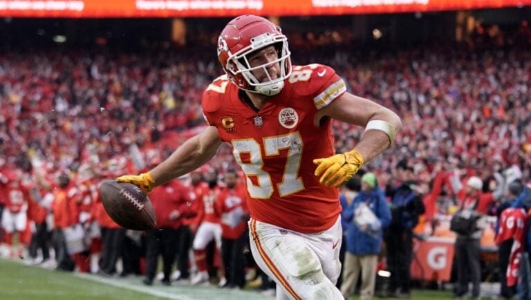 Kansas City Chiefs tight end Travis Kelce scores a touchdown against the Jacksonville Jaguars during an NFL Divisional Playoff football game Saturday, Jan. 21, 2023, in Kansas City, Mo. (AP Photo/Ed Zurga)