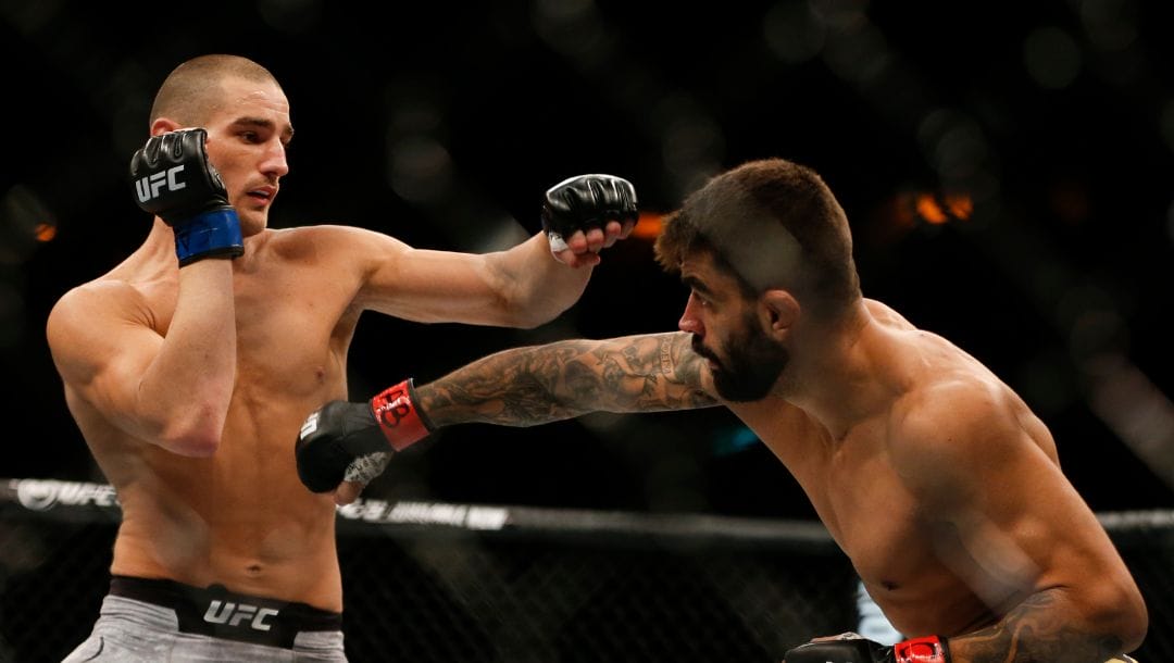 Sean Strickland, from the United States, left, and Elizeu Zaleski dos Santos, from Brazil, fight during their UFC welterweight mixed martial arts bout.