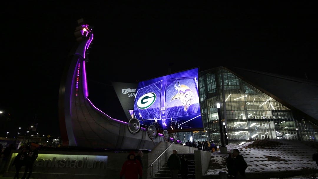 Fans arrive at U.S. Bank Stadium before an NFL football game between the Minnesota Vikings and the Green Bay Packers, Monday, Dec. 23, 2019, in Minneapolis. (AP Photo/Andy Clayton-King)