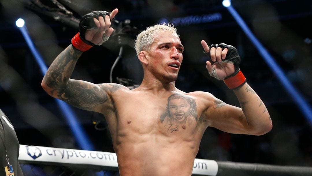 Charles Oliveira reacts after defeating Dustin Poirier by submission in a lightweight mixed martial arts title bout at UFC 269.