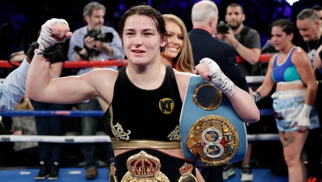 Ireland's Katie Taylor poses for photographs after winning a women's lightweight championship boxing match.