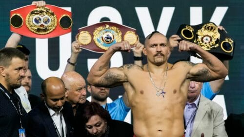 Heavyweight boxer Ukraine's Oleksandr Usyk gestures as he weighs in at King Abdullah Sports City in Jeddah, Saudi Arabia.